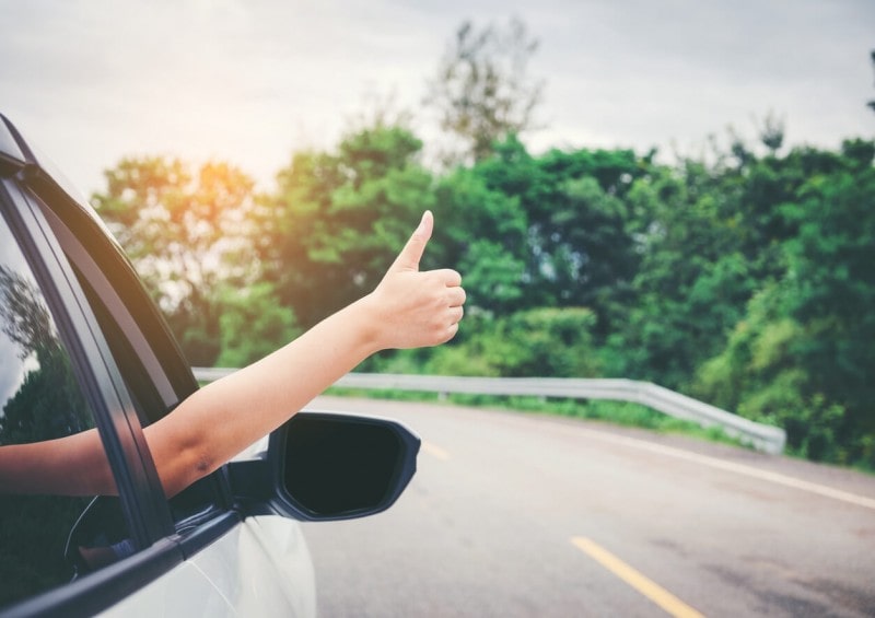 Thumbs up outside front car window